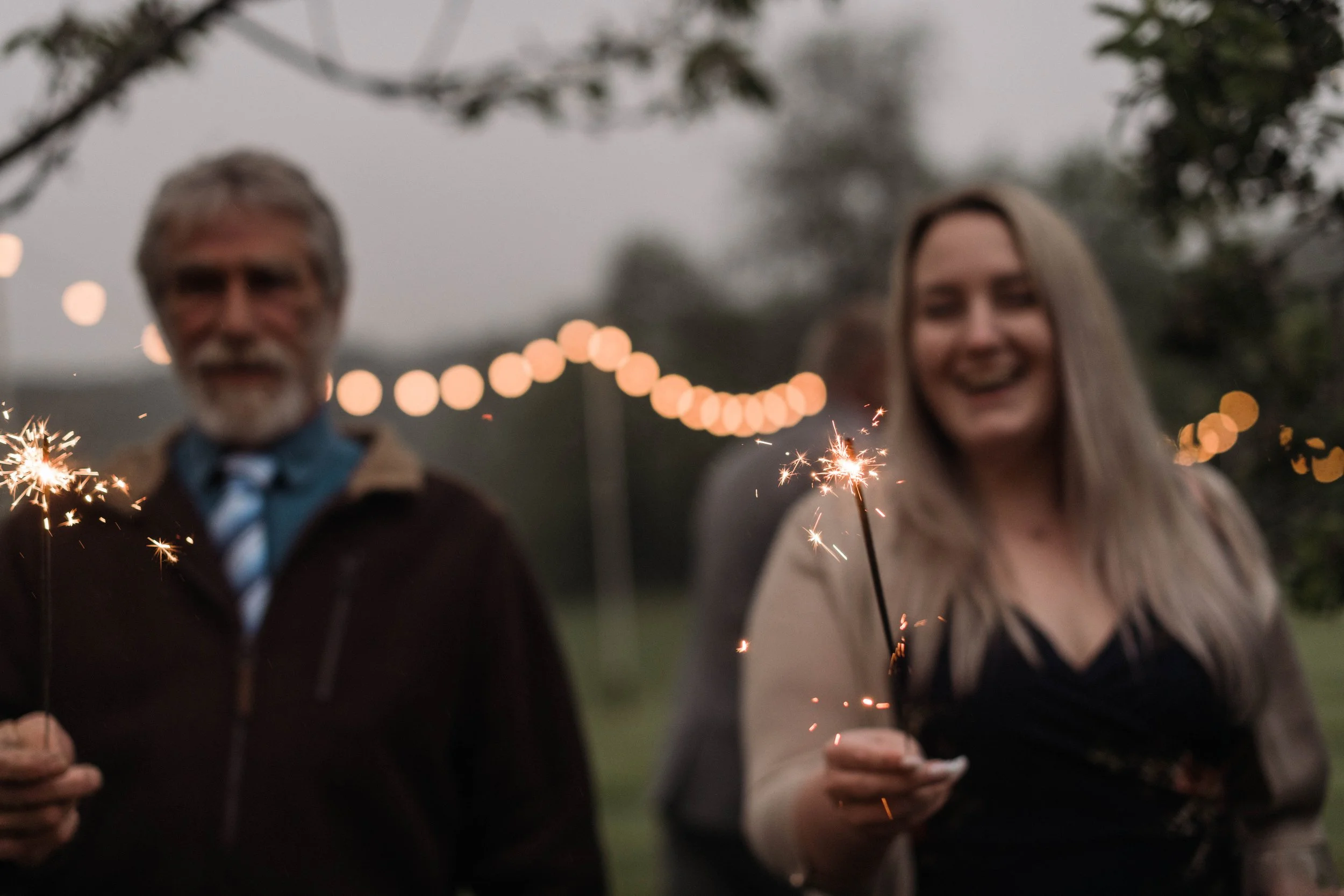 sparkler magic at outdoor spring wedding in cornwall with bokeh and sparkles