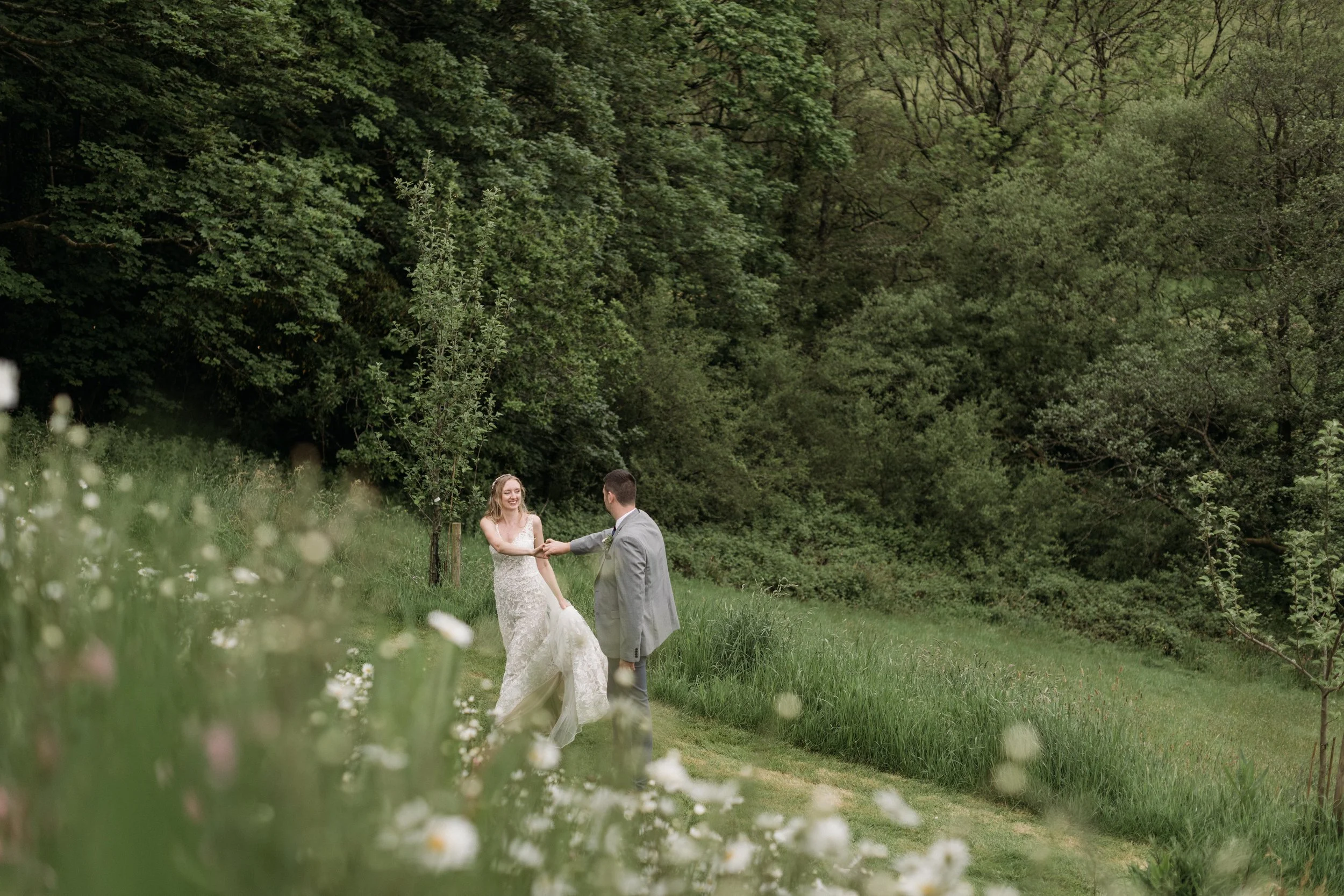 intimate wedding in June at pengenna manor where bride and groom are dancing among the wildflowers
