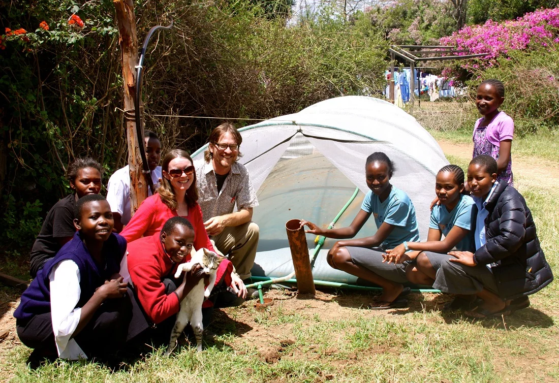 Marilyn and Chris pose with students at Daraja Academy in Kenya.