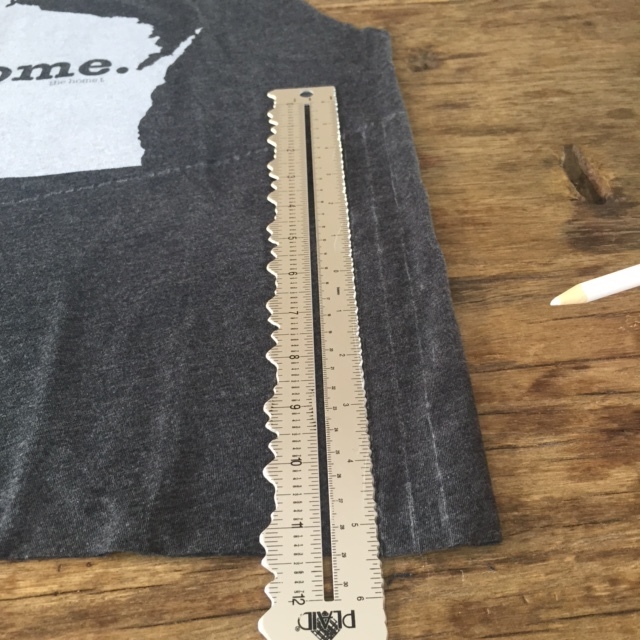 Keep the tee shirt perfectly flat and create a guide for the fringe cuts. I measured each fringe at a 1/2 inch wide. You only need to make the lines on one side of the tee shirt. 