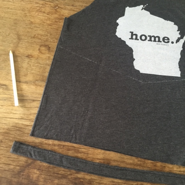 Here's the final "v" shape in white pencil. Next, cut off the bottom strip of the tee. 