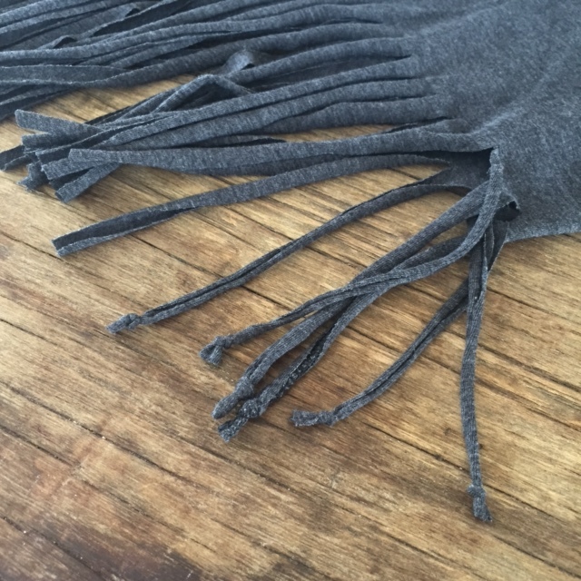 When you finish cutting all of the fringe, I like to tie each one at the bottom. You don't have to do this step, but I think it makes it look more finished and gives the fringe more of a weight that helps it dangle better. 