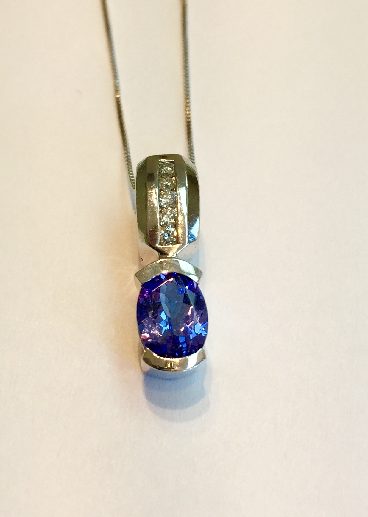 Item no. 221 USD425 14k White Gold Tanzanite and Diamond pendant. Nice .85 tanzanite with 5 accent diamonds. Contemporary and classic at the same time. 2.4 grams