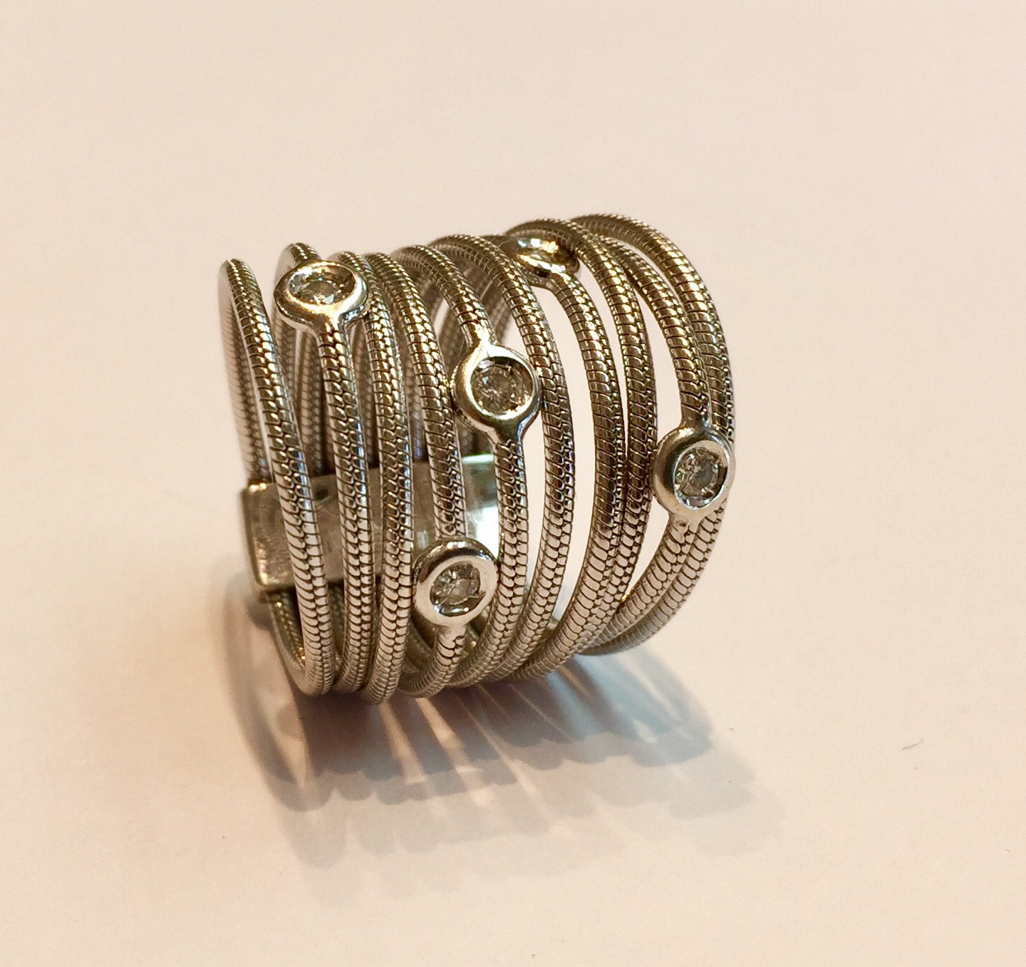 Item No A145 USD845 18K White Gold Diamond Ring A ring by Italian designer Piero Milano. 10 strands to this contemporary and eye catching band ring. 5 lovely white diamonds and a substantial 11.2 grams, put it all together and this is an amazing deal. 
