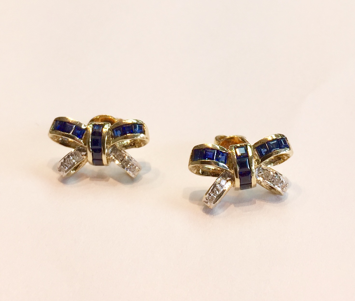 Item No AB47 USD 475 14K Yellow Gold Blue Sapphire and Diamond Earrings Lovely bow earrings, with princess cut blue sapphire and round diamonds. Quality craftsmanship. 