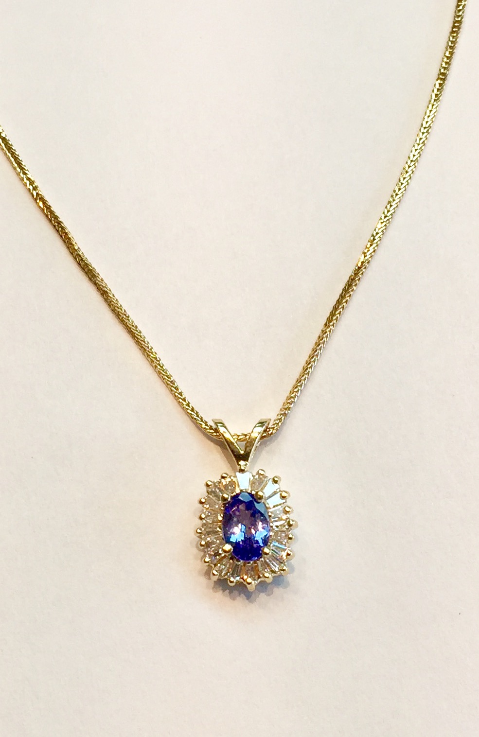 Item AB57 USD645 14k Yellow Gold Tanzanite and Diamond Pendant/Necklace Superior quality all around with a approximately .6 carat of lavender colored tanzanite with 20 clean sparkling baguette diamonds, approximately .4 carat. A nice chain too. Really a very nice piece of jewelry at a great price. 
