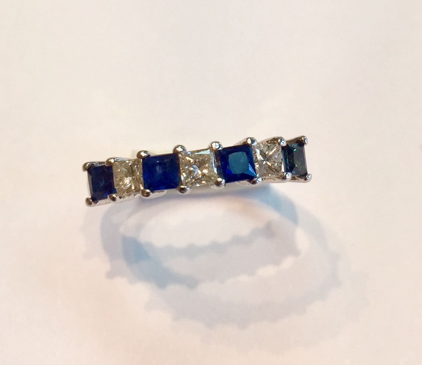 AB64 USD645 14K White Gold Blue Sapphire and Diamond Ring Classic and timeless ring with 3 quality princess cut diamonds and 4 quality princess cut sapphires. .36 carat of diamonds and .6 carat of diamonds. 