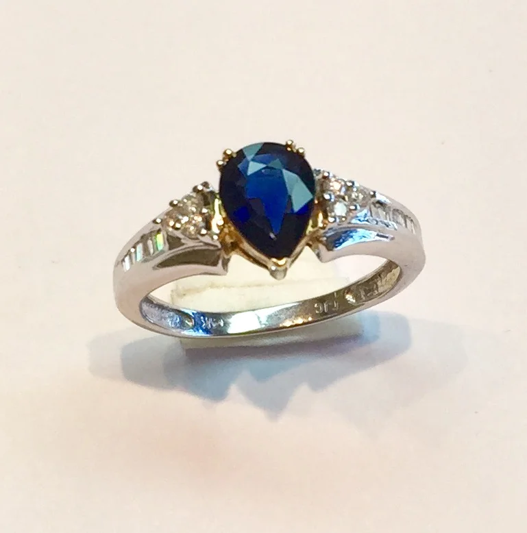 Item no AB57 USD445 14k White and Yellow Gold Sapphire and Diamond Ring Madagascar blue pear shaped sapphire weighing .84 carat set in 14k yellow gold accented with round and white diamonds weighting .18 carat and are all set in 14k white gold. Delightful