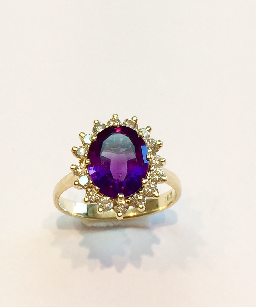Item no. AB99 USD675 14k Yellow Gold Amethyst Diamond Ring A classic halo amethyst and diamond ring. A 3 carat dark amethyst with some unusual and eye catching cutting, its subtle but really enhances the look of the stone. Surrounded by clean white diamonds that weight .48 carat. Truly a lovely ring. 