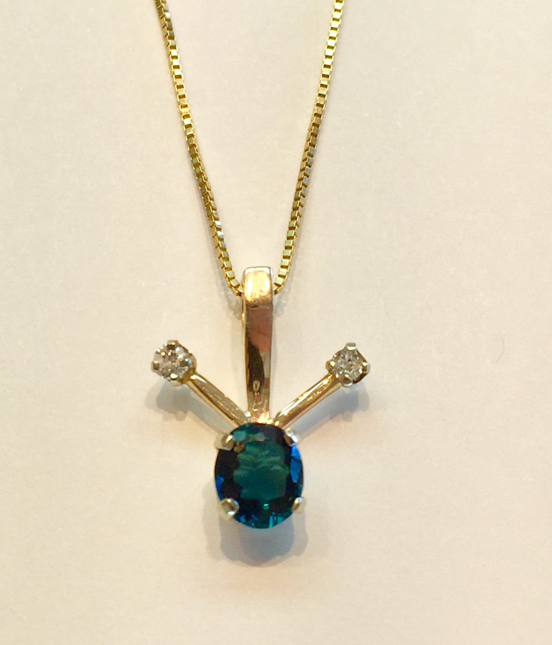 Item no. AB103 USD445 14k Yellow Gold Spinel and Diamond Necklace A modern necklace with a delightful blue/green/teal colored spinel weighing approximately 1 carat that is accompanied by two diamonds weighting approximately .12 carat. Unusual, unique and original.