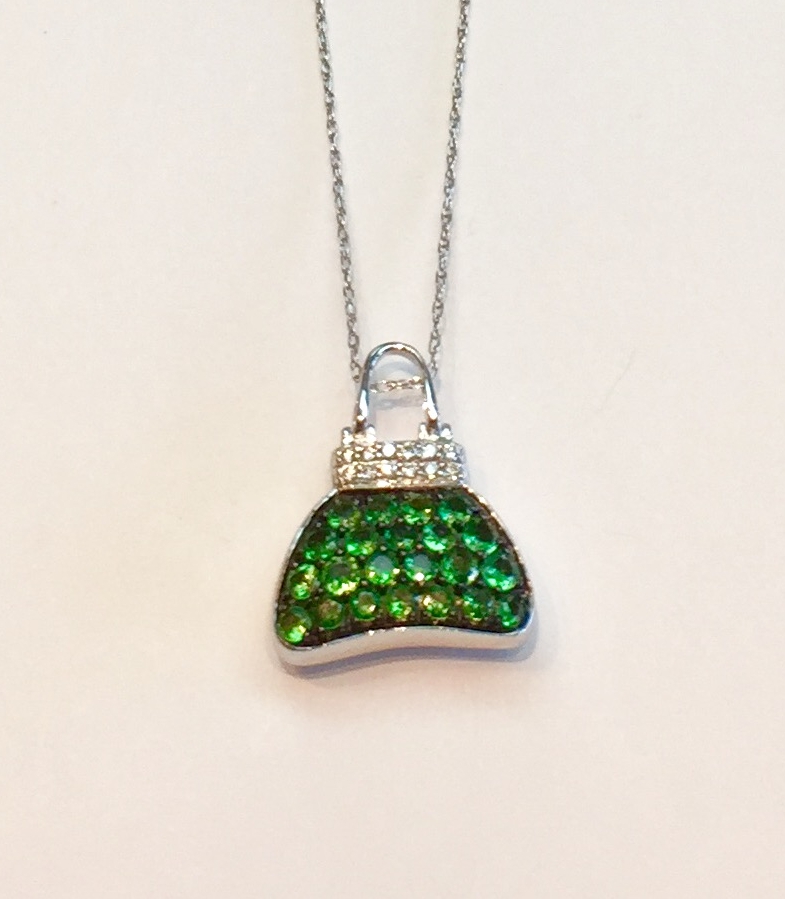 Item No. AB132 USD695 Stamped 18k White Gold Diamond and Tsavorite Pendant with 18k chain. Fashionable and high quality Mirabelle purse pendant (M on back with signature diamond) Mirabelle was co owned by Elizabeth Taylor and produced highly prized jewelry. I particularly like this pendant as i am a big fan of Tsavorites. 