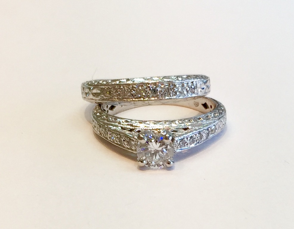 Item No. A77 USD1,750 (for the set) Platinium Diamond Wedding Set A very clean and bright .57 carat center diamond with a further .20 in diamonds complimenting it. Great filagree and milgrain work on this lovely substantial set. Weight is 10.7 grams. 