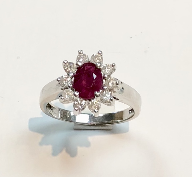 Item no. 373 US$1,045 for the set Stamped 14k White Gold Ruby and Diamond Ring and Earring Set Classically designed set with approximately a 1.1 carat high quality ruby centre in the ring, surrounded by 10 lovely white shiny diamonds weighing approximately .40 carats. Also classically designed petite earrings, with equal quality diamonds and rubies. Ring 4 grams, earrings 1.2 grams
