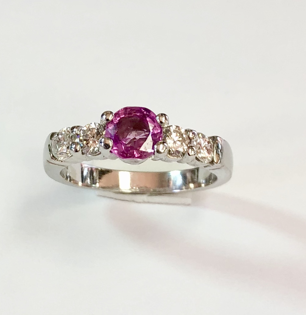 Item no. 326 US$1,245 Stamped platinum Pink Sapphire and Diamond Ring. Approximately 1 carat quality pink sapphire with two high quality diamonds flanking it on each side. Diamonds weigh approximately .6 carats. You cannot go wrong with this ring, it is perfect. 6.35 grams