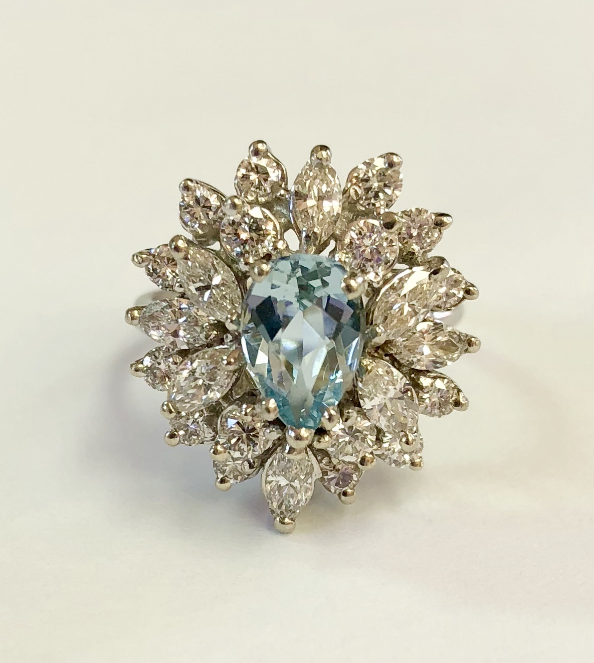 Item No AB80 USD1,495 14k White Gold Aquamarine and Diamond Ring Simply stunning, 2 plus carats of shimmering diamonds, marquis and round cuts, surround a pear shaped high quality aquamarine that weighs approximately 1.3 carats. The combination of quality and beauty is all there is this gem, excuse the pun. A very fine piece of jewelry at a very fine price. 