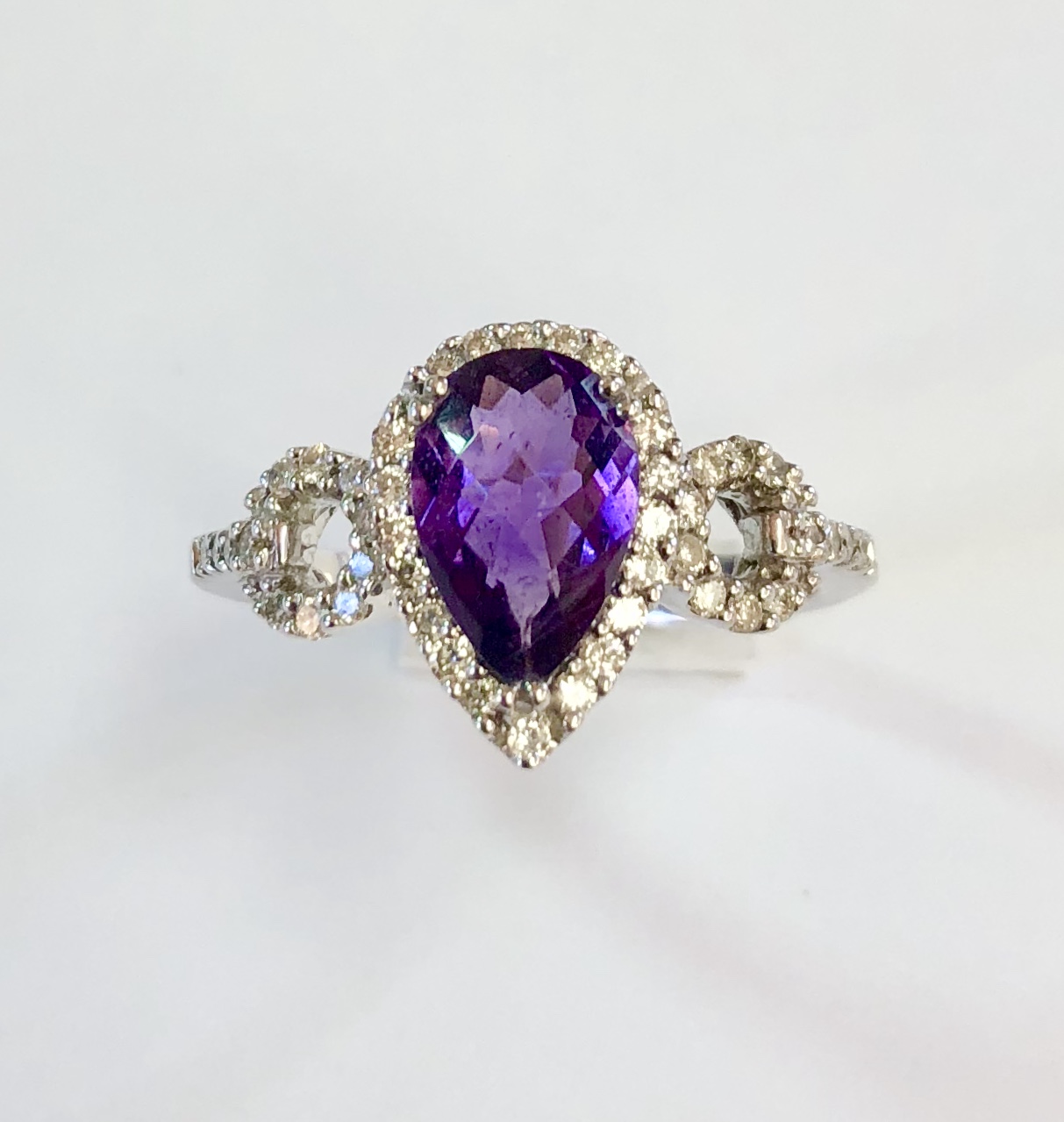 Item No. A 94 USD545 14K White Gold Amethyst and Diamond Ring An approximately 1.7 carat checkerboard cut dark amethyst gemstone is surrounded by a halo of high quality diamonds in this really nice ring. Matches perfectly with necklace No. A93 for USD745. 