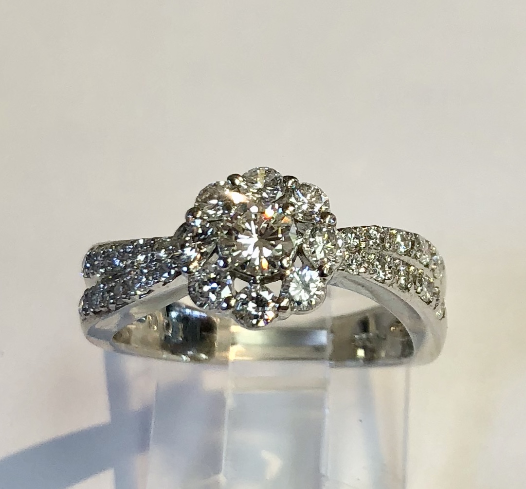 Item no. 239 USD1,250 Platinum Diamond Ring. Stunning quality in this ring, a .25 carat diamond centre with a halo of sparkling diamonds and even more round diamonds down the side. Nobody could miss this ring on your finger. a solid 7.9 grams