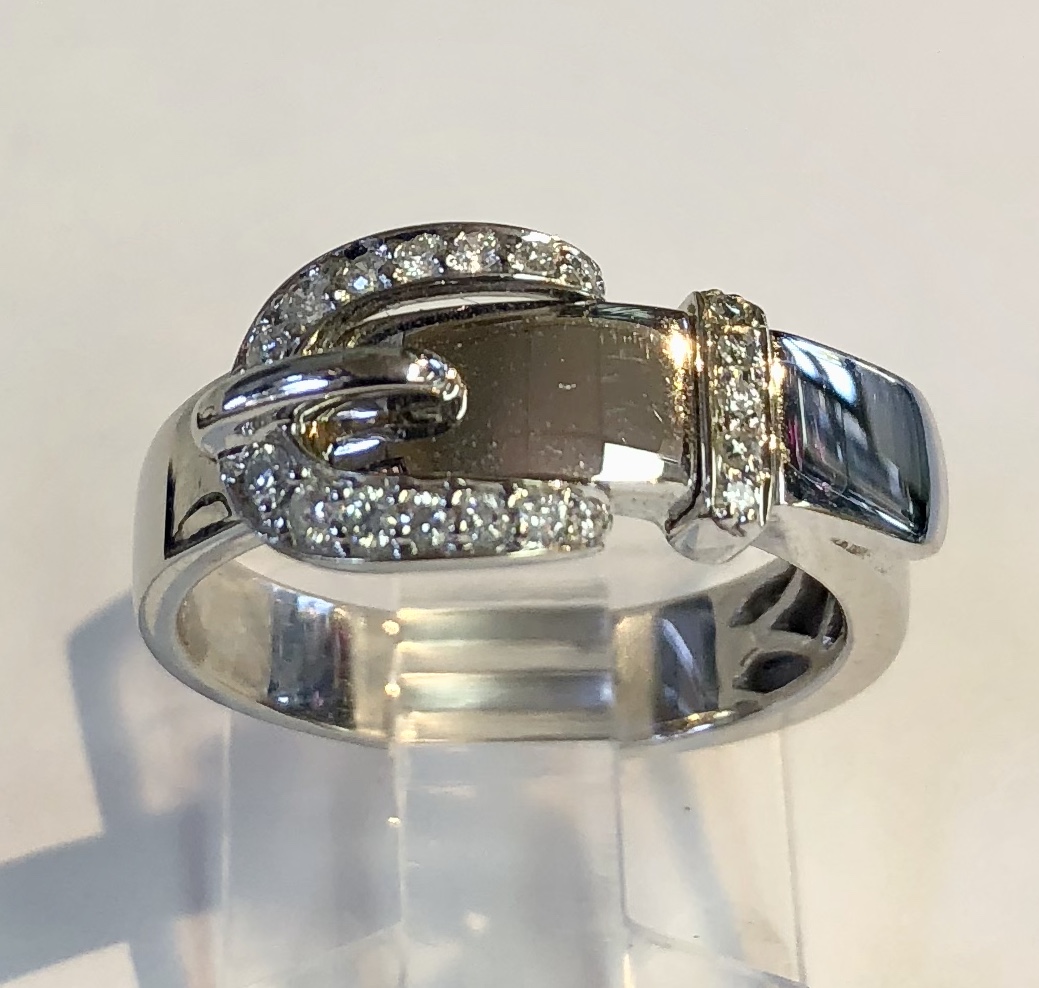 Item no. 295 USD545 Stamped 14k White Gold Diamond Ring. This 'buckle' ring is great quality and very elegant. 4.8 grams