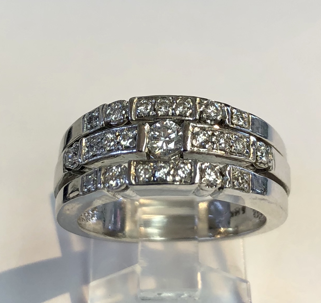 Item no A97 USD645 14k White Gold Diamond Ring Great looking ring with the look of three rings but the convenience of it being only one. Lovely quality .11 carat center diamond with a total of .44 carat for the ring. A substantial 7.9 grams. 
