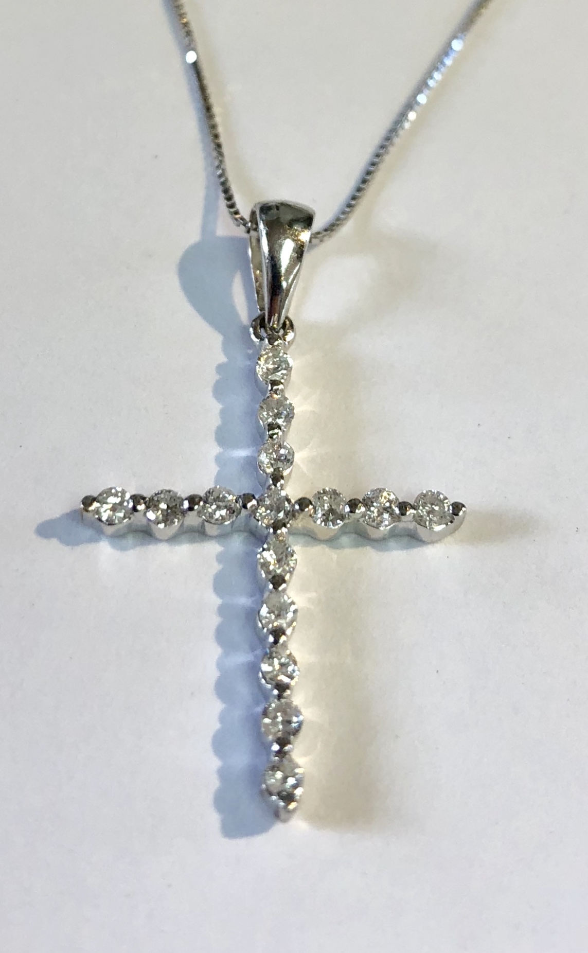 Item no. 179 USD375 Stamped 18k White Gold Diamond Cross Necklace. 15 small high quality diamonds weighing .25 of a carat make this an understated and classy piece of jewelry. 2.0Grams
