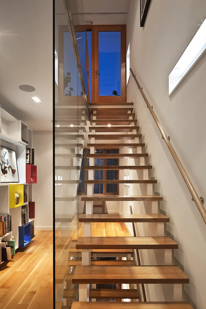 View up stair to third floor and roof deck