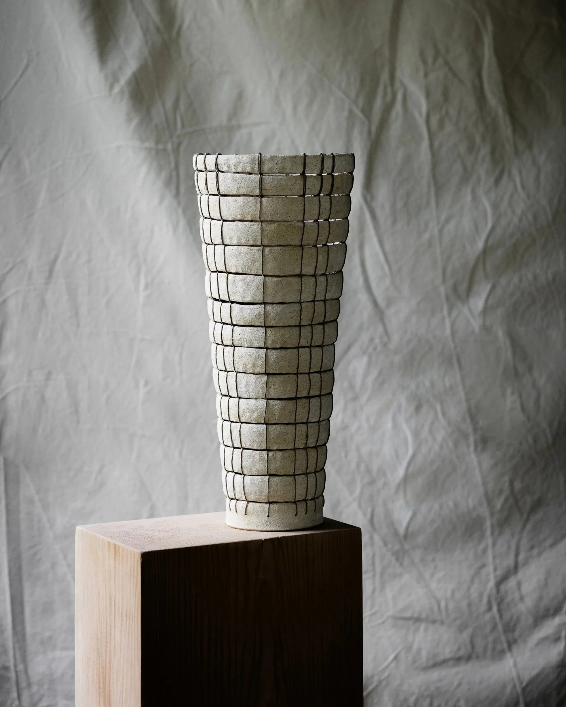 A woven stoneware ceramic vessel handmade by Cara Taylor