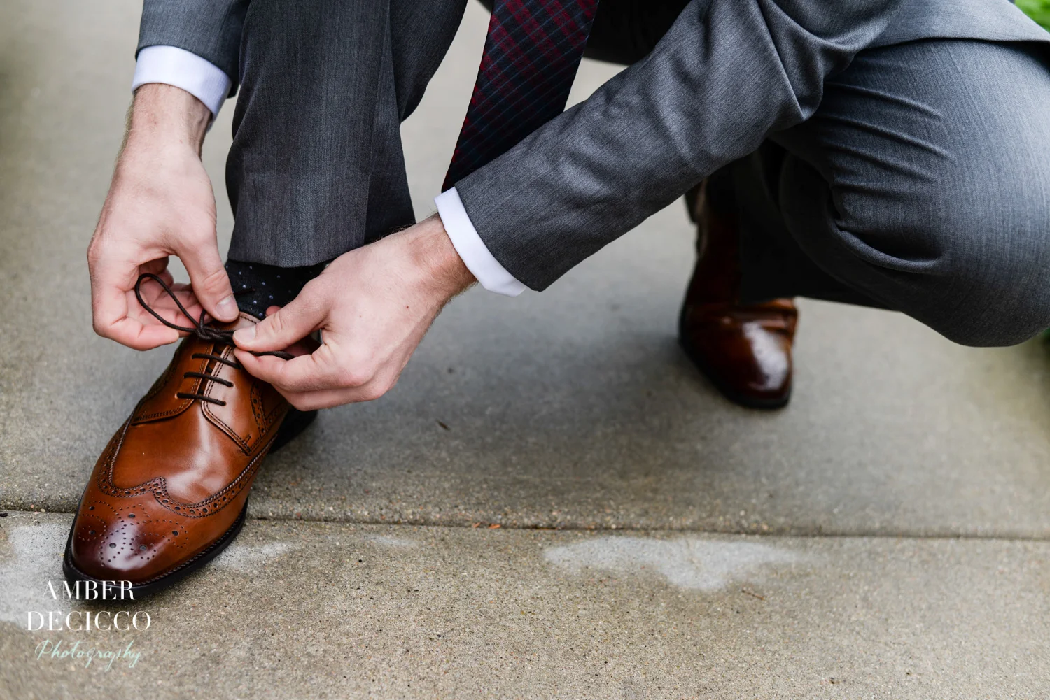 Groom Tying His Shoe on His Wedding Day