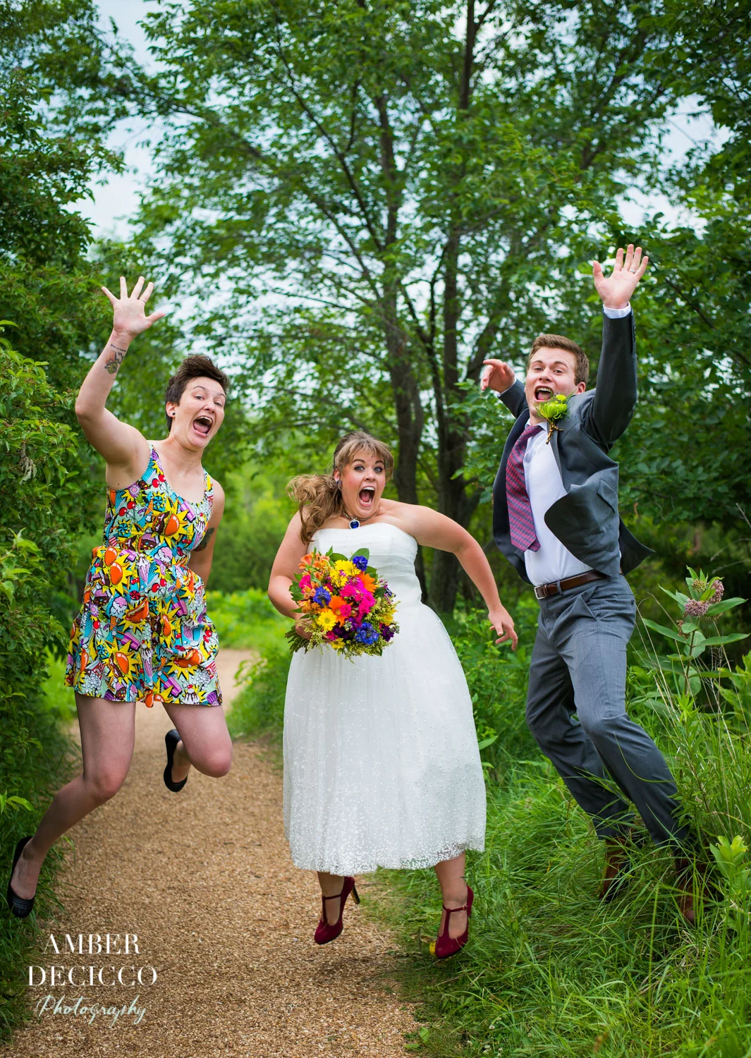 Bride, Groom and Maid of Honor Jumping in Excitement