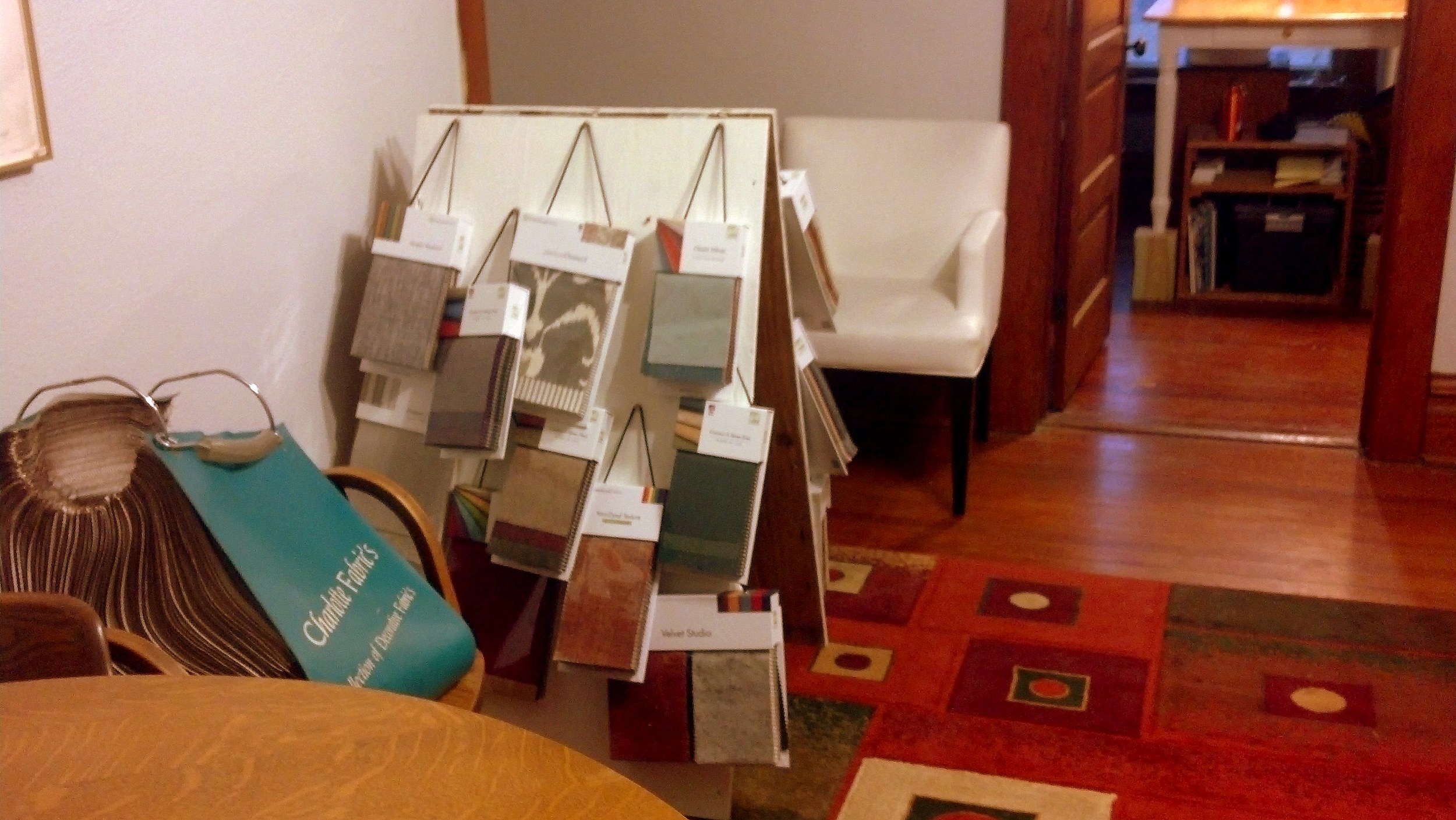 The other side of the show room where I have fabric samples.  I have about 30 books at the moment with samples from Greenhouse Fabrics and Charlotte Fabrics.  The sandwich board holding my fabric books is now in its third life - it has bee…