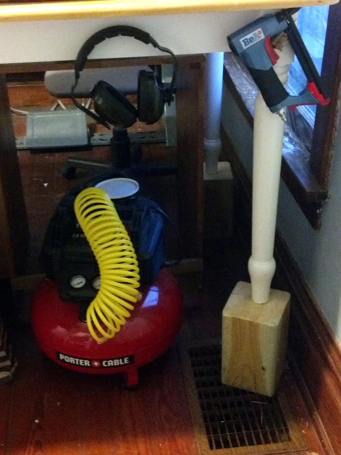 My pancake air compressor and its friends, the staple gun and earmuffs.  A pneumatic staple gun is a must for professional upholstery and this portable air compressor works well for my needs.  I wear earmuffs when I use it though, because …