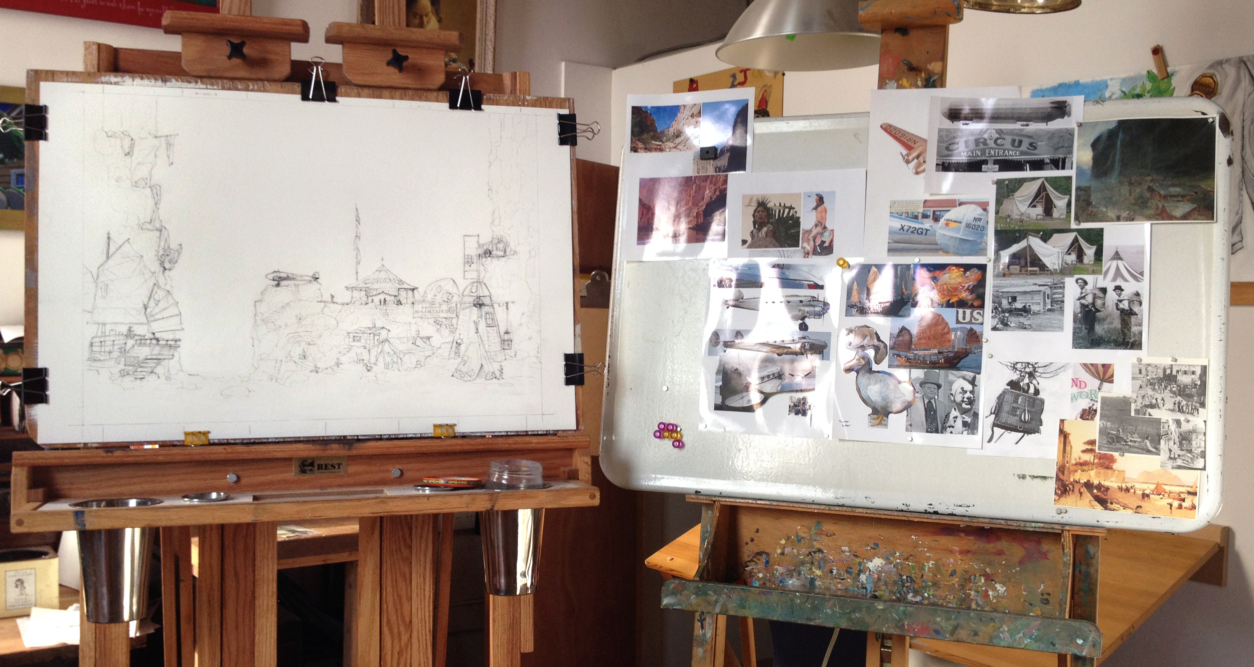 Working on The Aviator's Camp . One easel held the painting (here shown only sketched onto the illustration board) and one easel to hold all my reference photos.