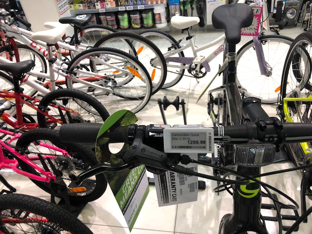 Digital price tags clamped onto bike frames