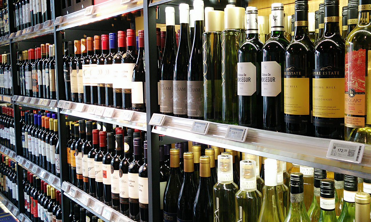 ESLs attached to wine shelves in a bottle shop