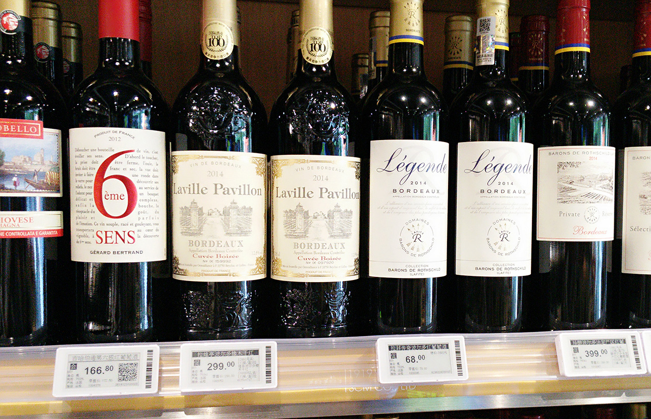 Bottle shop wine shelf with digital price labels