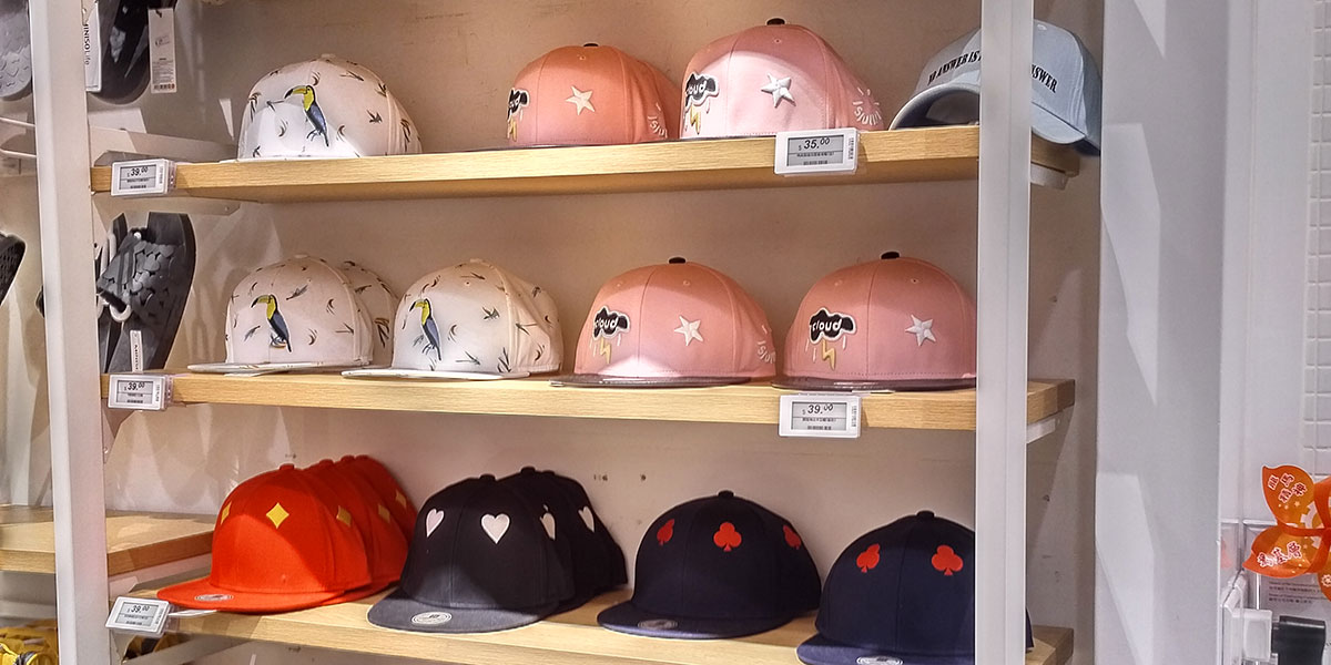 Electronic shelf labels used for hats on shelves in an apparel store