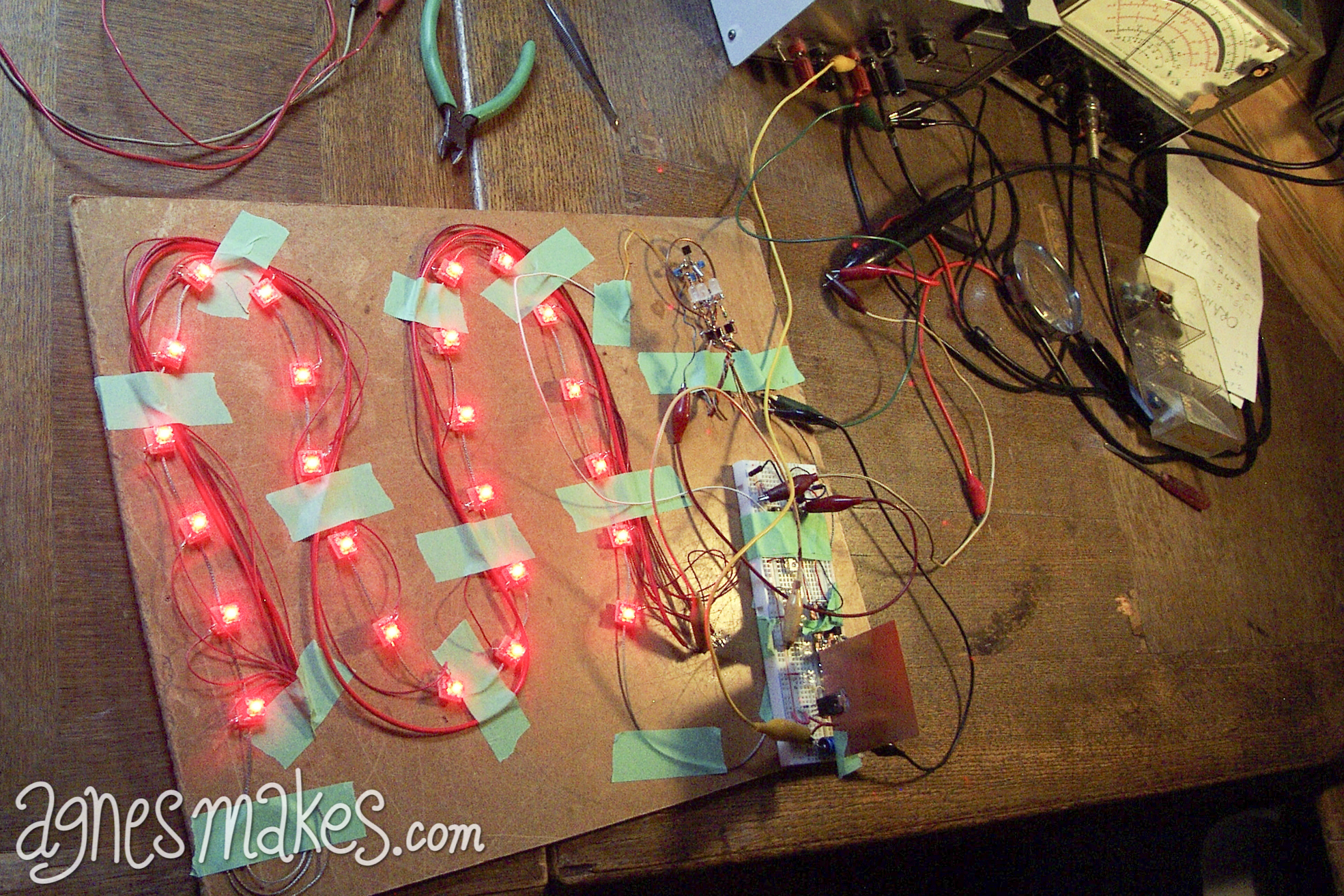 Bernie tests out his beating heart circuit at home. The string of red LEDs pulse the lights in a rhythm, just like a real heartbeat. The lights also vary in brightness as the "heart" ticks away.