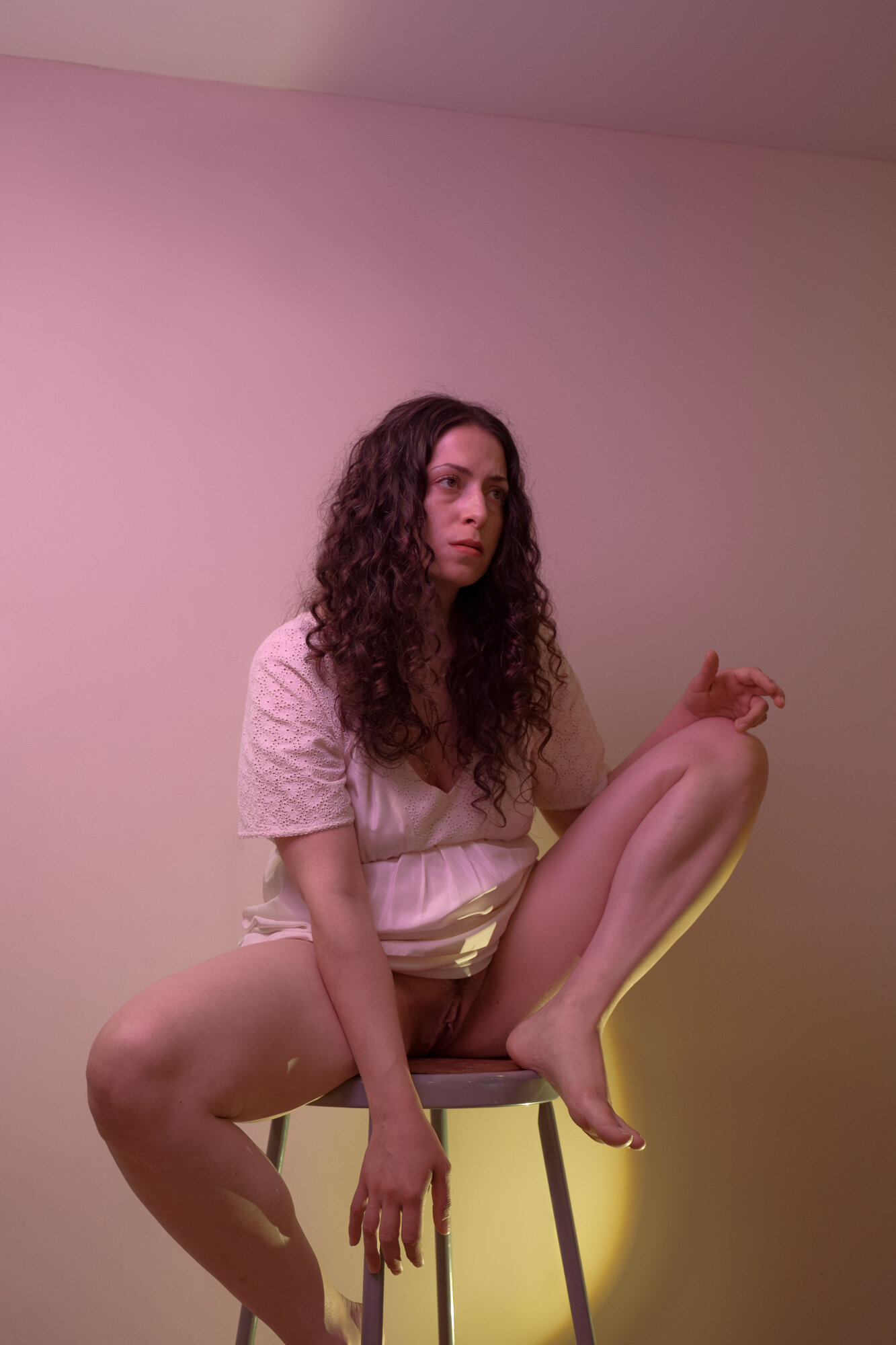 Hannah in a White Dress Under Pink Light