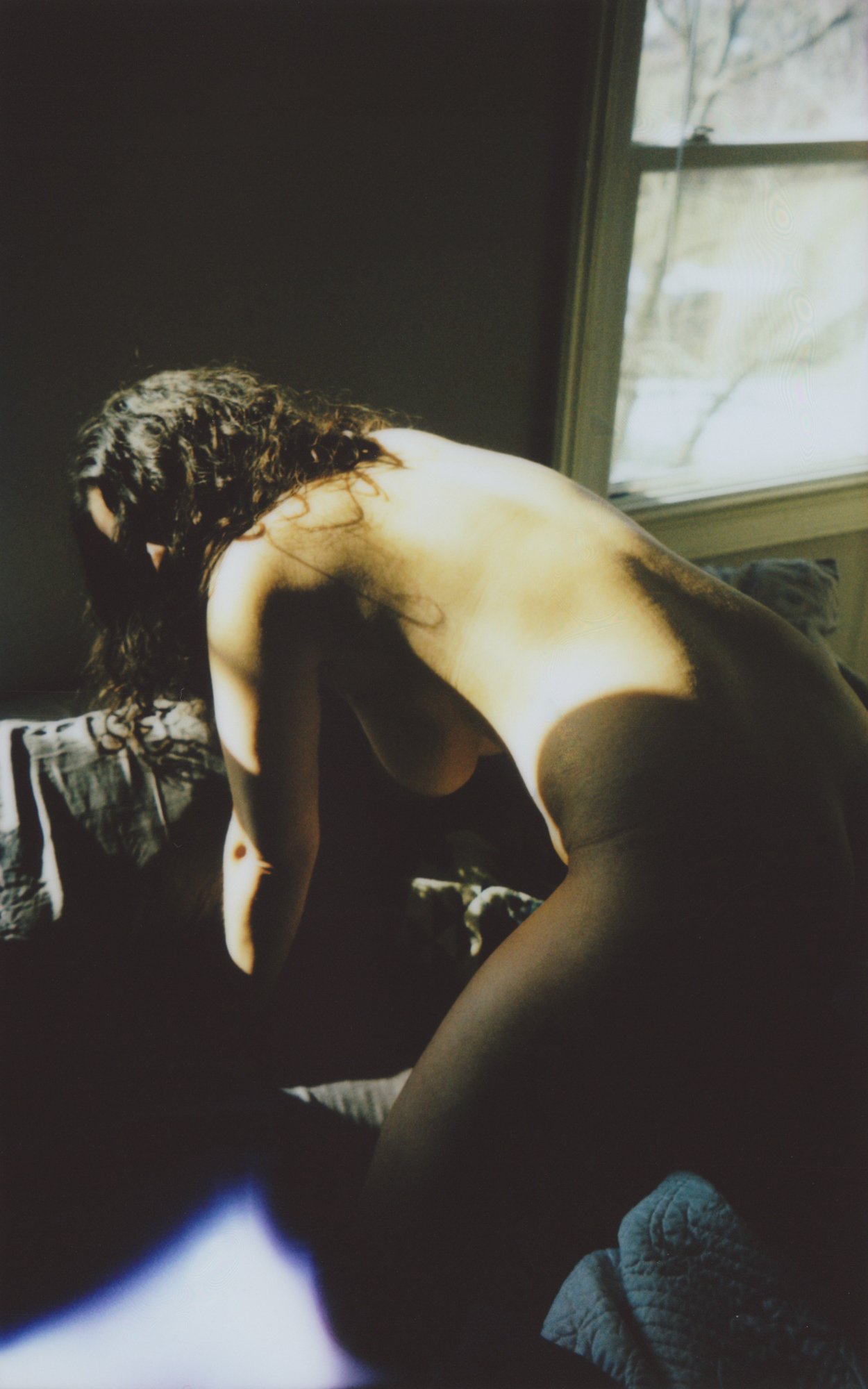 Hannah Hunched on the Bed