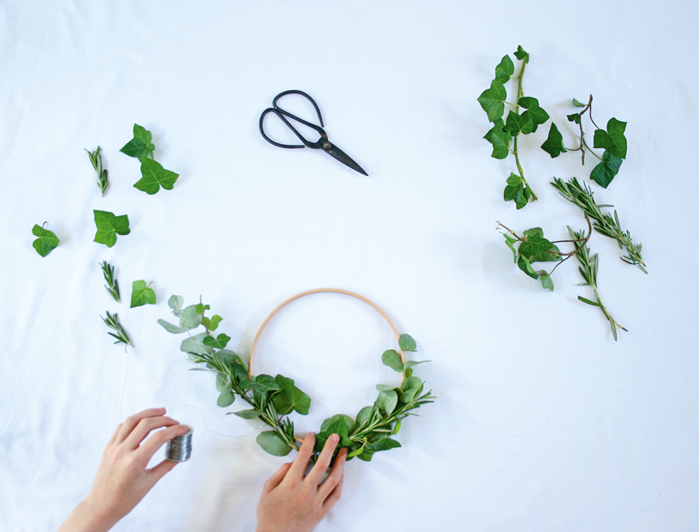  1 Gather two near-identical bunches of foliage and bind them together with wire. Attach the foliage bunches to the wooden hoop, securing at intervals with wire. Allow the two bunches to overlap slightly at the base of the hoop to hide the join. Any 