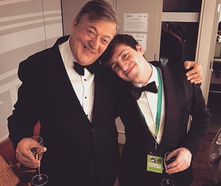 Alex Edelman in his GANDHUM Buta Motif Cocktail Jacket at the BAFTA's alongside Stephen Fry