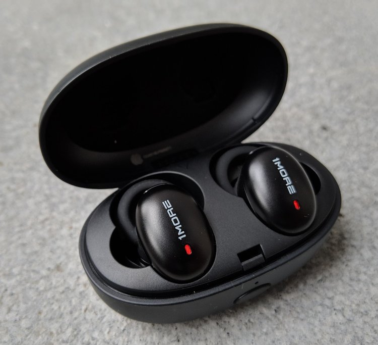 The 1more stylish true wireless earphones charging in their carry case.
