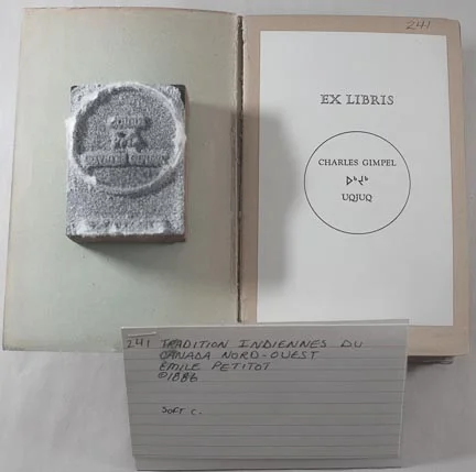 This is what Bob suspects is the magnesium plate used for Charles Gimpel's bookplate. Wil obviously knew Gimpel because he printed his bookplates for his ex libris. Kinngait studios inherited Gimpel's entire arctic library when he died and in every book there was attached the book plate pictured here. His Inuit name was "Ugjuq" or Bearded Seal. The actual plate was wrapped the same way the others were only it didn't survive as long. Bits of the paper is still attached to the plate and the plate is still attached to the wooden support used to render it "type high". I have made it known that we'd like to have these plates conserved but I have yet to hear back......