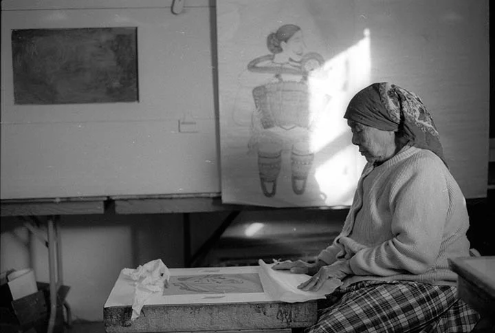 Atami Regge drawing on a litho stone. Note in the background is the aquatint box and to the right behind the drawing by Napachie of her accordian lady is the old acid bath compartment. This photo is a scan of a black and white negative I took "back in the day".
