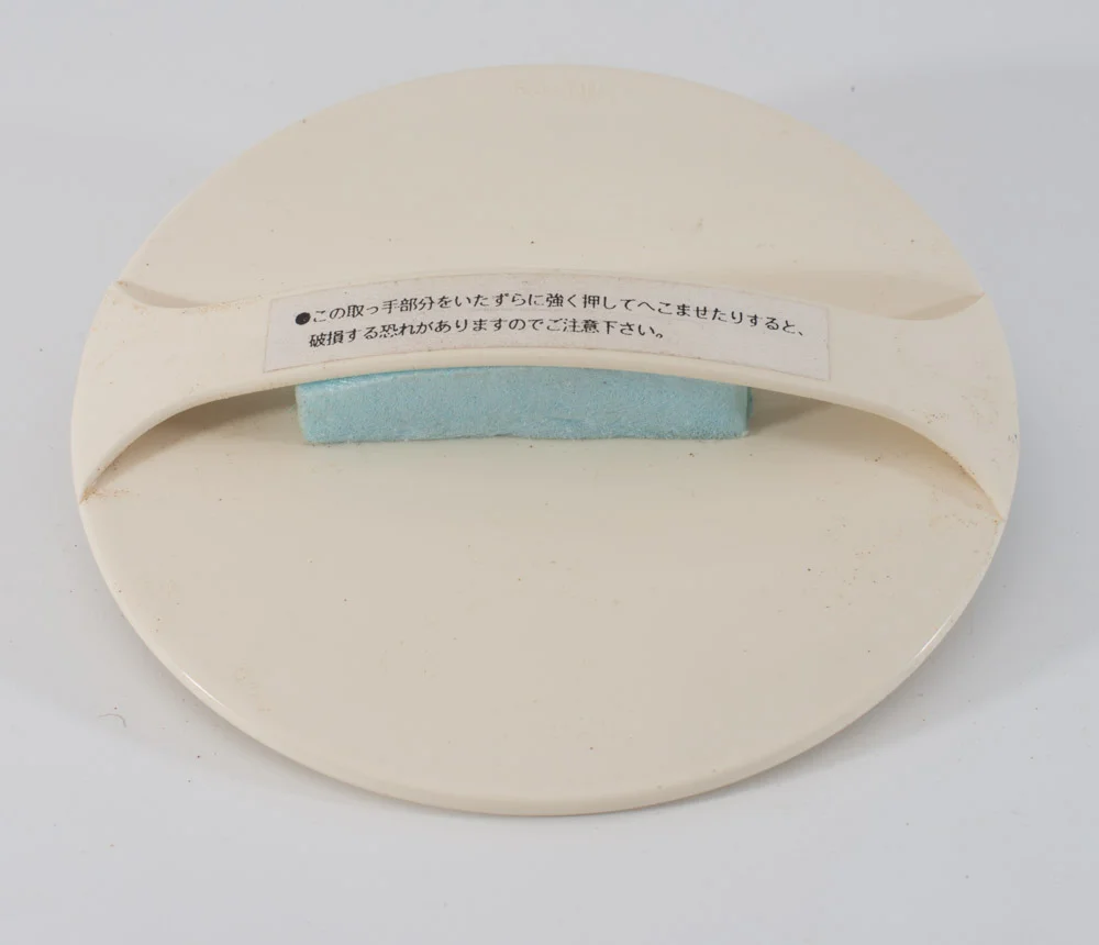 A beautiful baren designed not have to use the traditional cover. Apparently the blue foam was installed so the handle can be pinched easier. http://www.imcclains.com/catalog/baren/disk.html