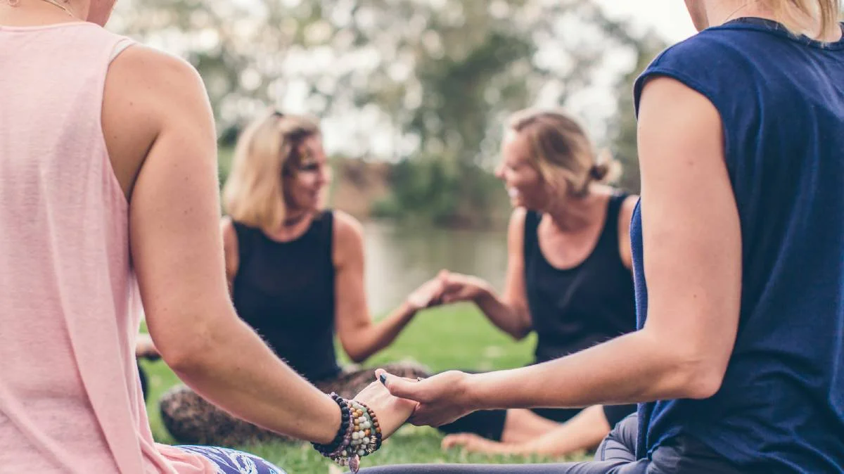 women holding hands circle.jpg