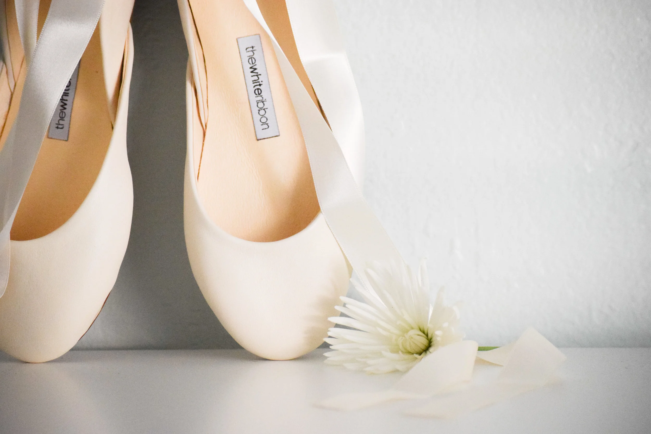 the white ribbon ballet flats