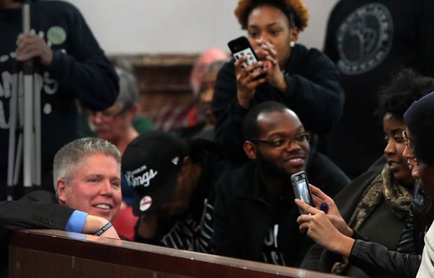 Protesters photograph Jeff Roorda, business manager of the St. Louis Police Officers Association, as he wears a bracelet that says "I am Darren Wilson" at a meeting of a proposed civilian oversight review board at City Hall on Wednesday, Jan. 28, 2015. Photo by Robert Cohen, rcohen@post-dispatch.com