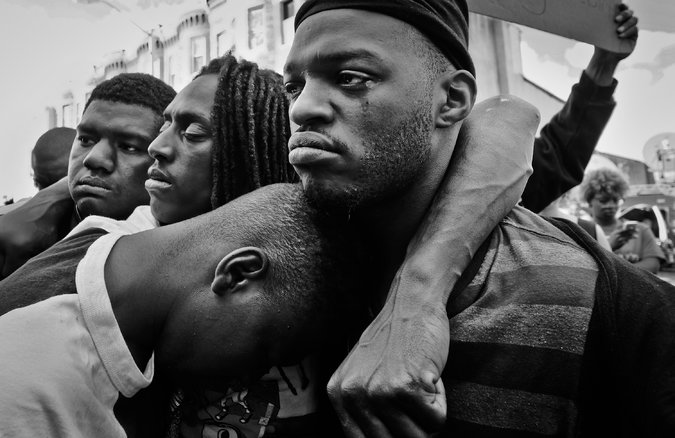 Protesters gathered in West Baltimore on Tuesday, near the burned-out CVS. Credit Yunghi Kim/Contact Press Images