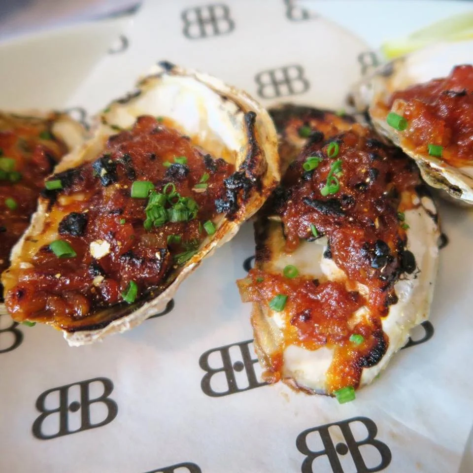 Oysters "Kilpatrick" with a bit of bacon, spicy BBQ sauce and chives
