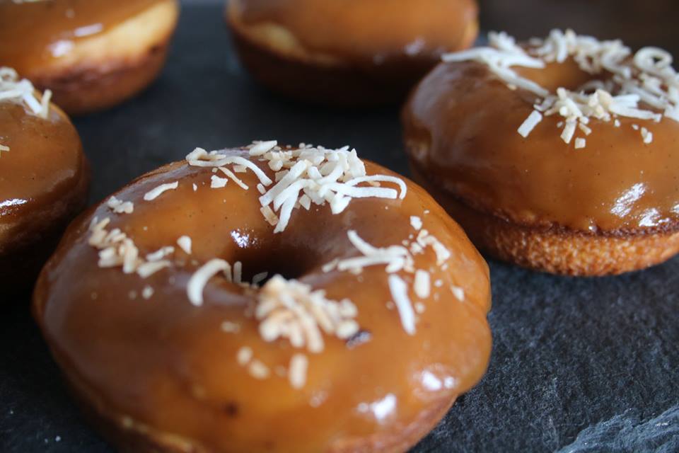 Caramel Glazed Vanilla Cake Doughnut topped with toasted coconut.jpg